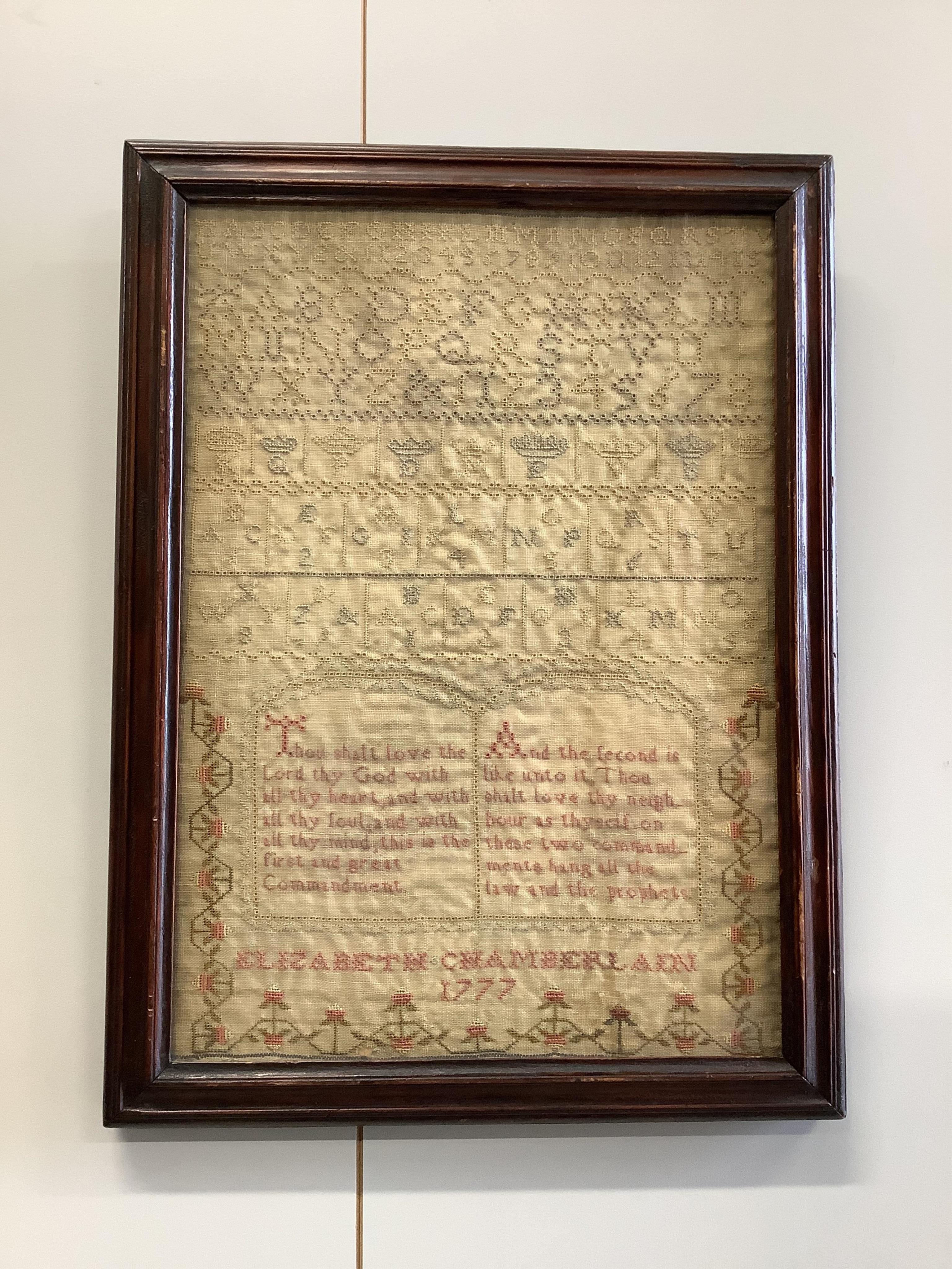 Two samplers; one late 18th century, the other early 20th century, the 18th century sampler by Elizabeth Chamberlain dated 1777, worked with an alphabet and framed verse bordered with vineous flowers, the later sampler b